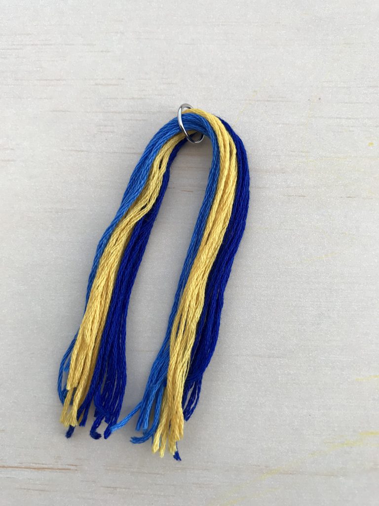 Keychain Tassel: Feed embroidery thread onto larger jump ring and center.