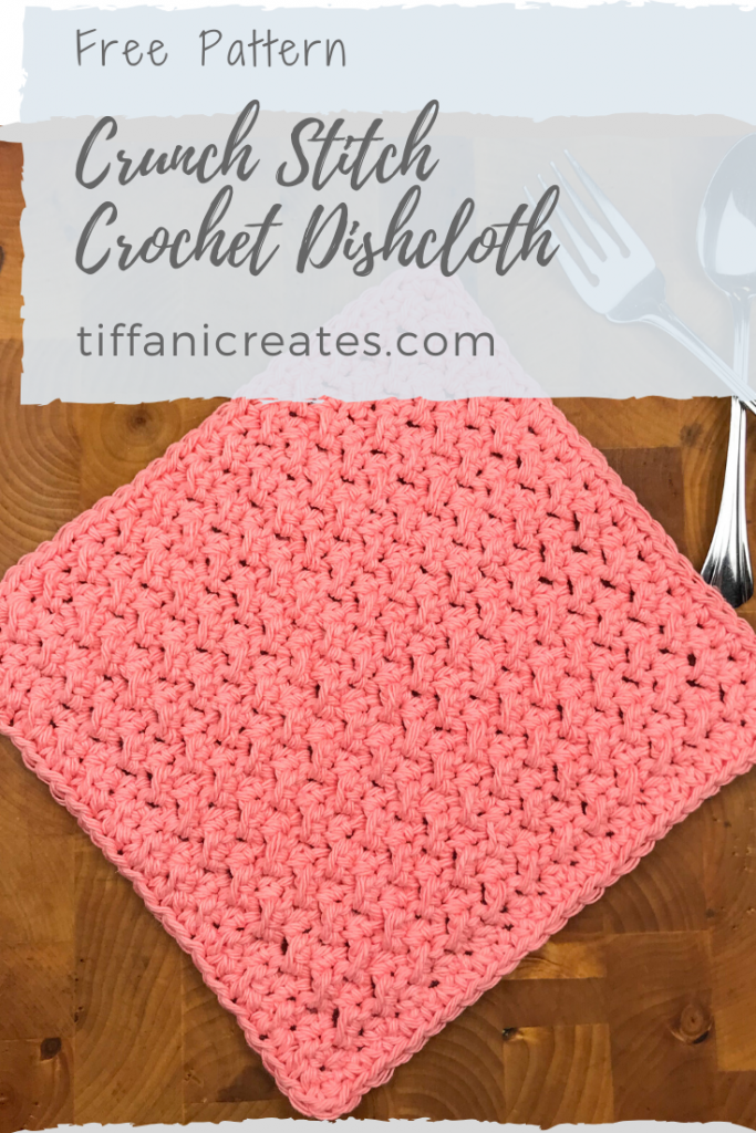 Pin it for later - Completed Crunch Stitch Dishcloth displayed on wooden cutting board with silverware.